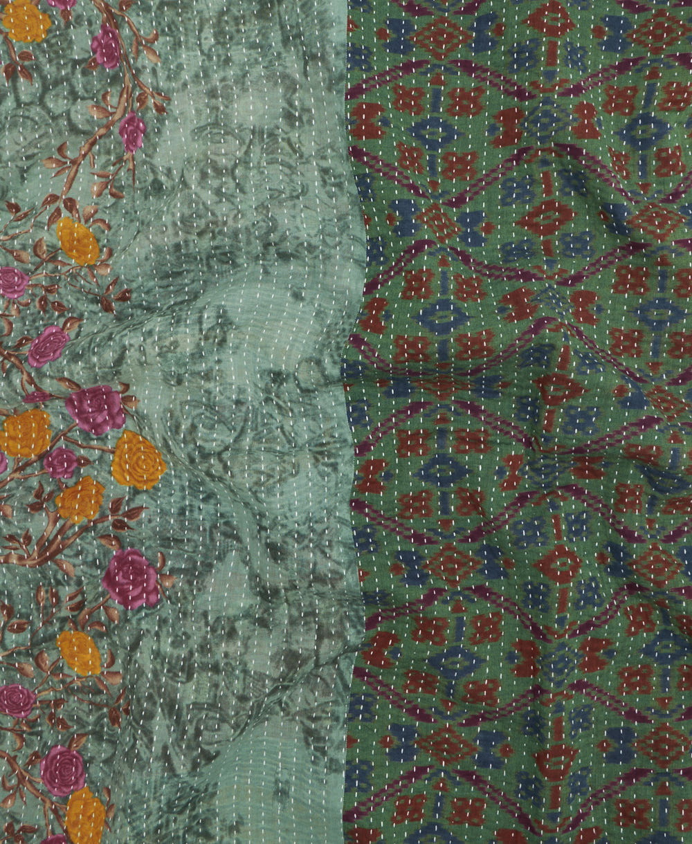 kantha quilt throw with a tag featuring the hand-stitched signature of the maker