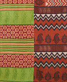 kantha quilt throw with a tag featuring the hand-stitched signature of the maker
