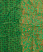 kantha quilt throw with a tag featuring the hand-stitched signature of the maker