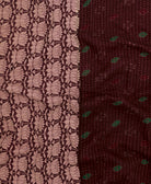 kantha quilt throw with a tag featuring the hand-stitched signature of the maker
