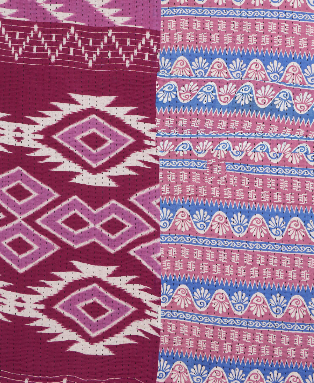 kantha quilt throw with a tag featuring the hand-stitched signature of the maker