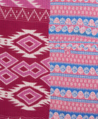 kantha quilt throw with a tag featuring the hand-stitched signature of the maker