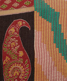 kantha quilt throw with a tag featuring the hand-stitched signature of the maker