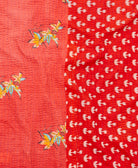 kantha quilt throw with a tag featuring the hand-stitched signature of the maker