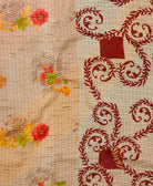 kantha quilt throw with a tag featuring the hand-stitched signature of the maker