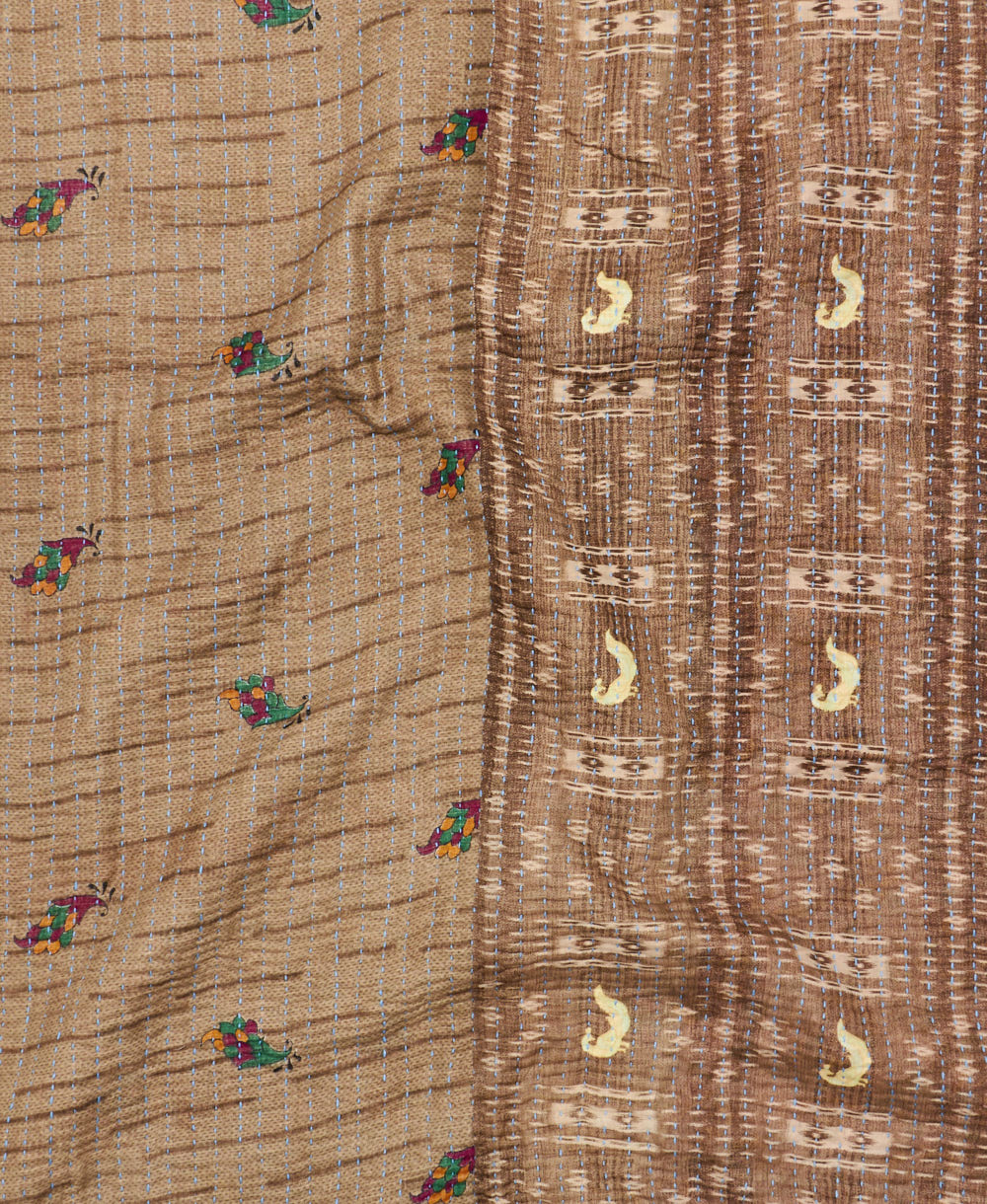 kantha quilt throw with a tag featuring the hand-stitched signature of the maker