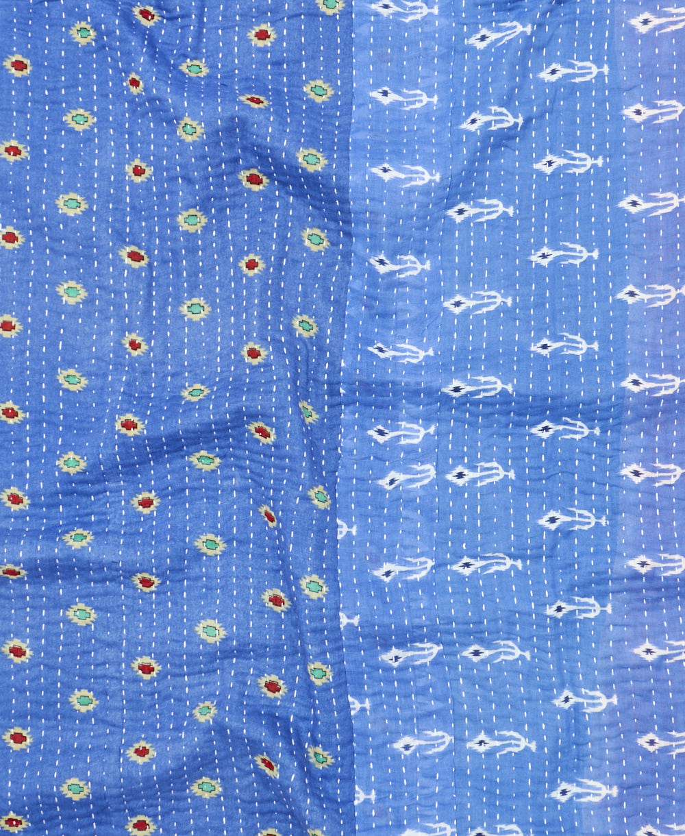 kantha quilt throw with a tag featuring the hand-stitched signature of the maker