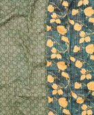 kantha quilt throw with a tag featuring the hand-stitched signature of the maker