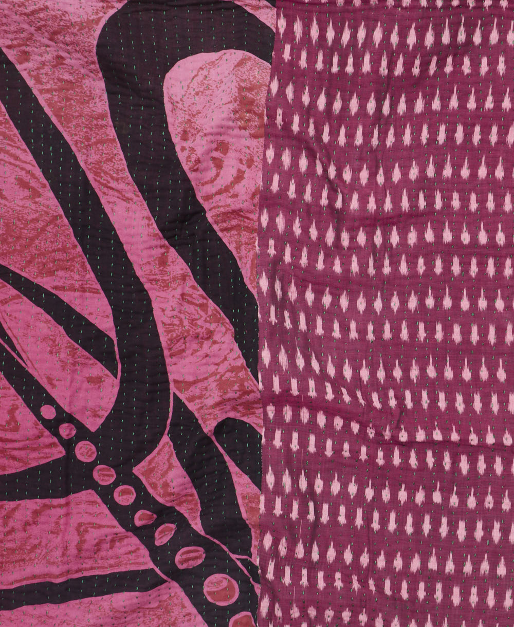 kantha quilt throw with a tag featuring the hand-stitched signature of the maker