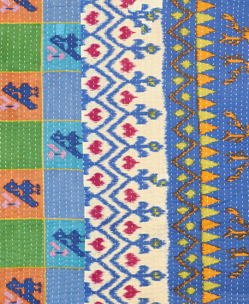 kantha quilt throw with a tag featuring the hand-stitched signature of the maker