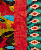 kantha quilt throw with a tag featuring the hand-stitched signature of the maker