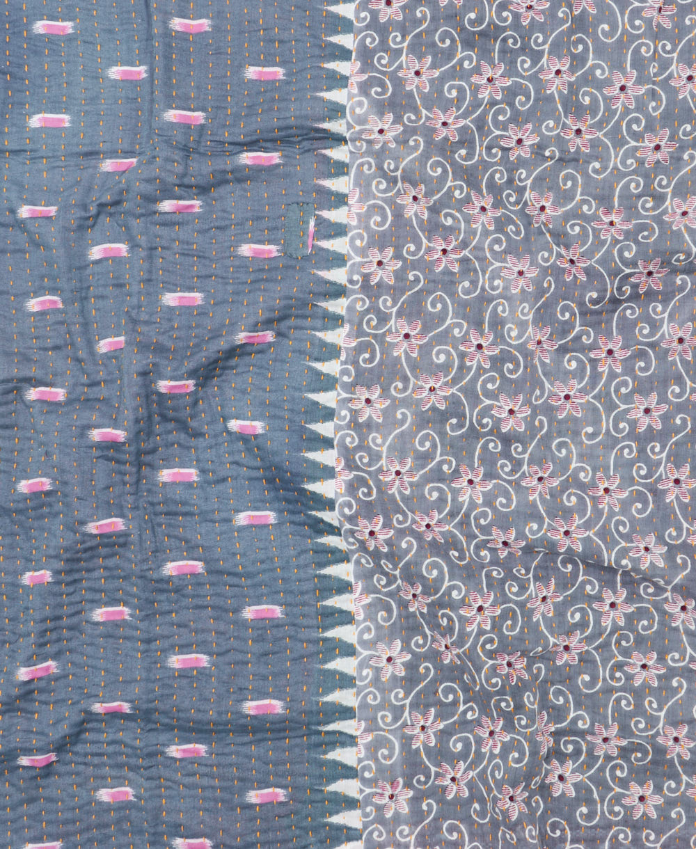 kantha quilt throw with a tag featuring the hand-stitched signature of the maker
