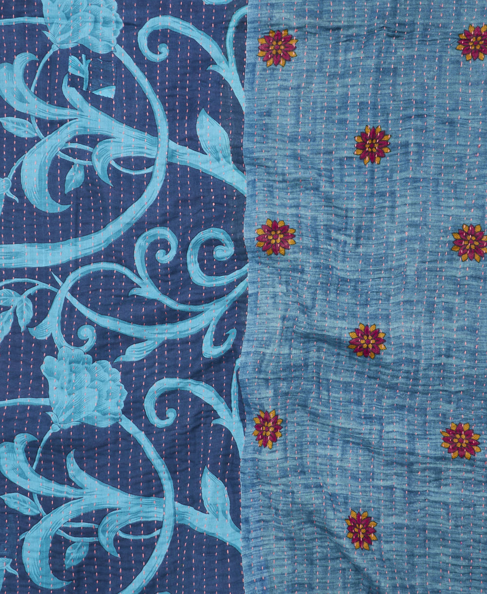 kantha quilt throw with a tag featuring the hand-stitched signature of the maker