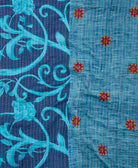 kantha quilt throw with a tag featuring the hand-stitched signature of the maker