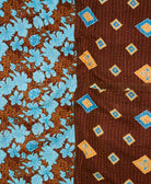 kantha quilt throw with a tag featuring the hand-stitched signature of the maker