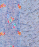 kantha quilt throw with a tag featuring the hand-stitched signature of the maker