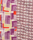 kantha quilt throw with a tag featuring the hand-stitched signature of the maker
