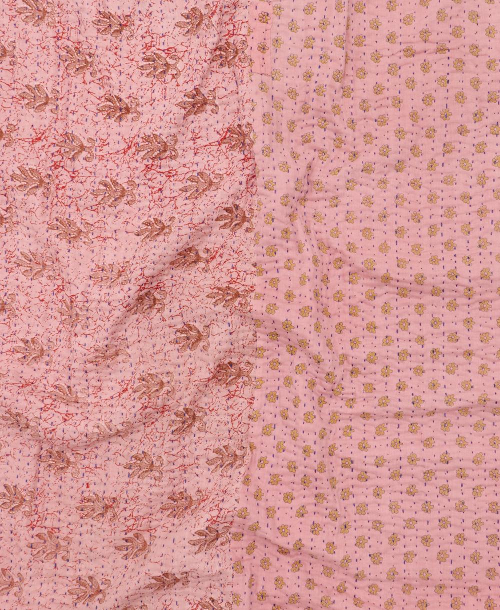 kantha quilt throw with a tag featuring the hand-stitched signature of the maker
