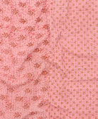 kantha quilt throw with a tag featuring the hand-stitched signature of the maker
