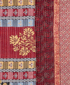 kantha quilt throw with a tag featuring the hand-stitched signature of the maker