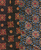 kantha quilt throw with a tag featuring the hand-stitched signature of the maker