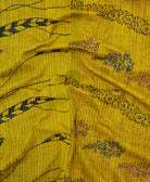 kantha quilt throw with a tag featuring the hand-stitched signature of the maker