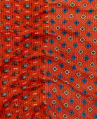kantha quilt throw with a tag featuring the hand-stitched signature of the maker