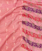 kantha quilt throw with a tag featuring the hand-stitched signature of the maker