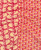 kantha quilt throw with a tag featuring the hand-stitched signature of the maker