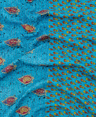kantha quilt throw with a tag featuring the hand-stitched signature of the maker