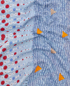 kantha quilt throw with a tag featuring the hand-stitched signature of the maker