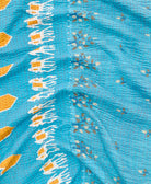 kantha quilt throw with a tag featuring the hand-stitched signature of the maker