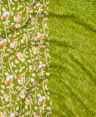 kantha quilt throw with a tag featuring the hand-stitched signature of the maker