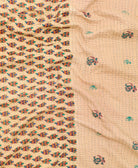kantha quilt throw with a tag featuring the hand-stitched signature of the maker