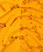 kantha quilt throw with a tag featuring the hand-stitched signature of the maker