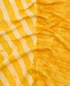 kantha quilt throw with a tag featuring the hand-stitched signature of the maker
