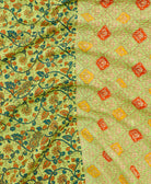 kantha quilt throw with a tag featuring the hand-stitched signature of the maker
