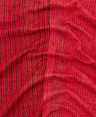 kantha quilt throw with a tag featuring the hand-stitched signature of the maker