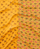 kantha quilt throw with a tag featuring the hand-stitched signature of the maker