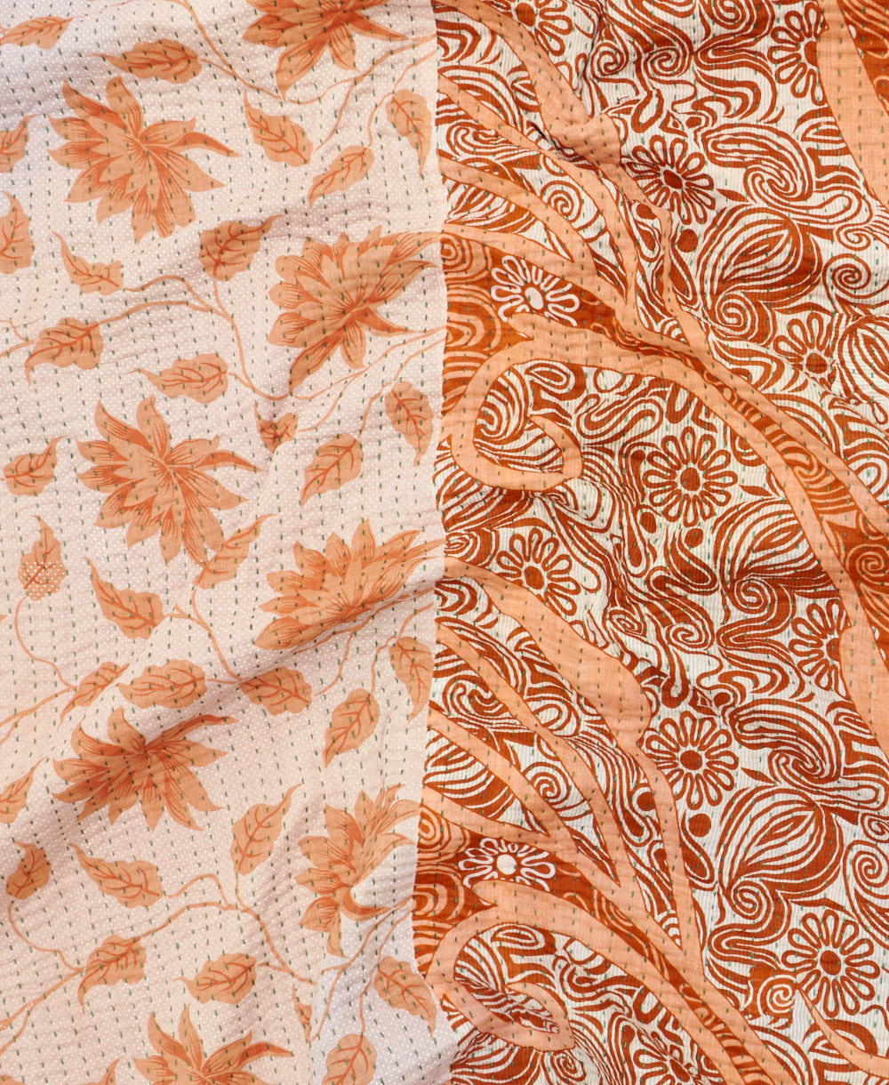 kantha quilt throw with a tag featuring the hand-stitched signature of the maker