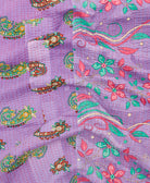 kantha quilt throw with a tag featuring the hand-stitched signature of the maker