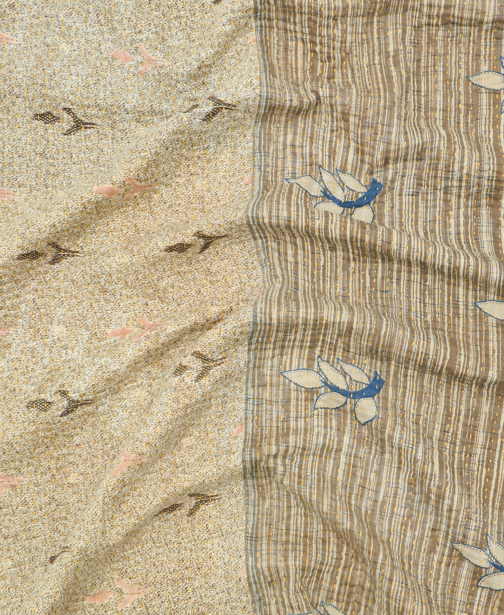 kantha quilt throw with a tag featuring the hand-stitched signature of the maker