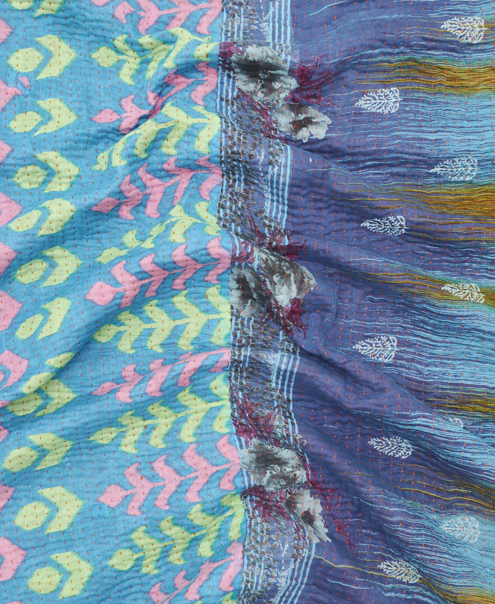 kantha quilt throw with a tag featuring the hand-stitched signature of the maker