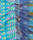 kantha quilt throw with a tag featuring the hand-stitched signature of the maker