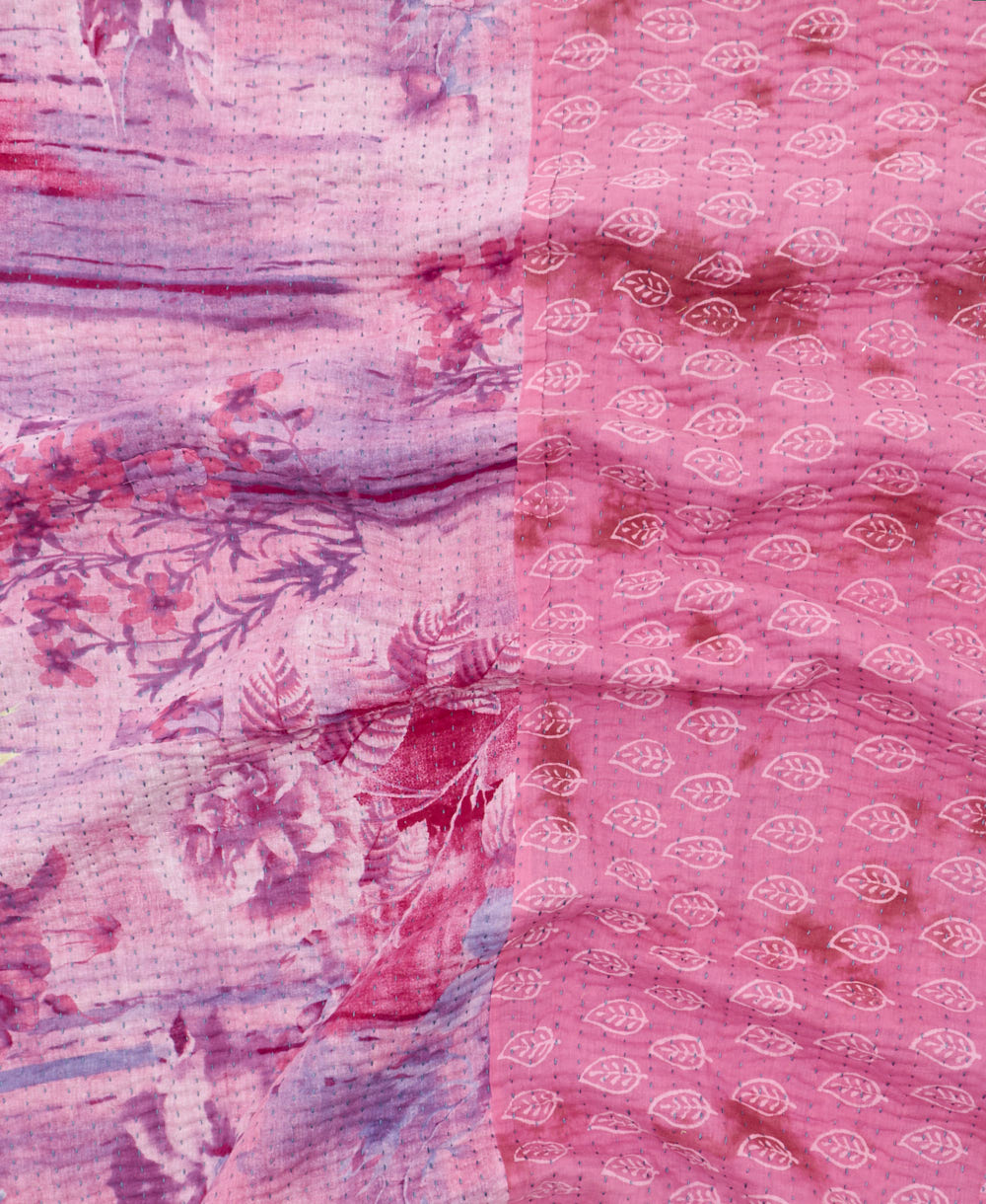 kantha quilt throw with a tag featuring the hand-stitched signature of the maker