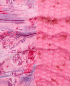 kantha quilt throw with a tag featuring the hand-stitched signature of the maker