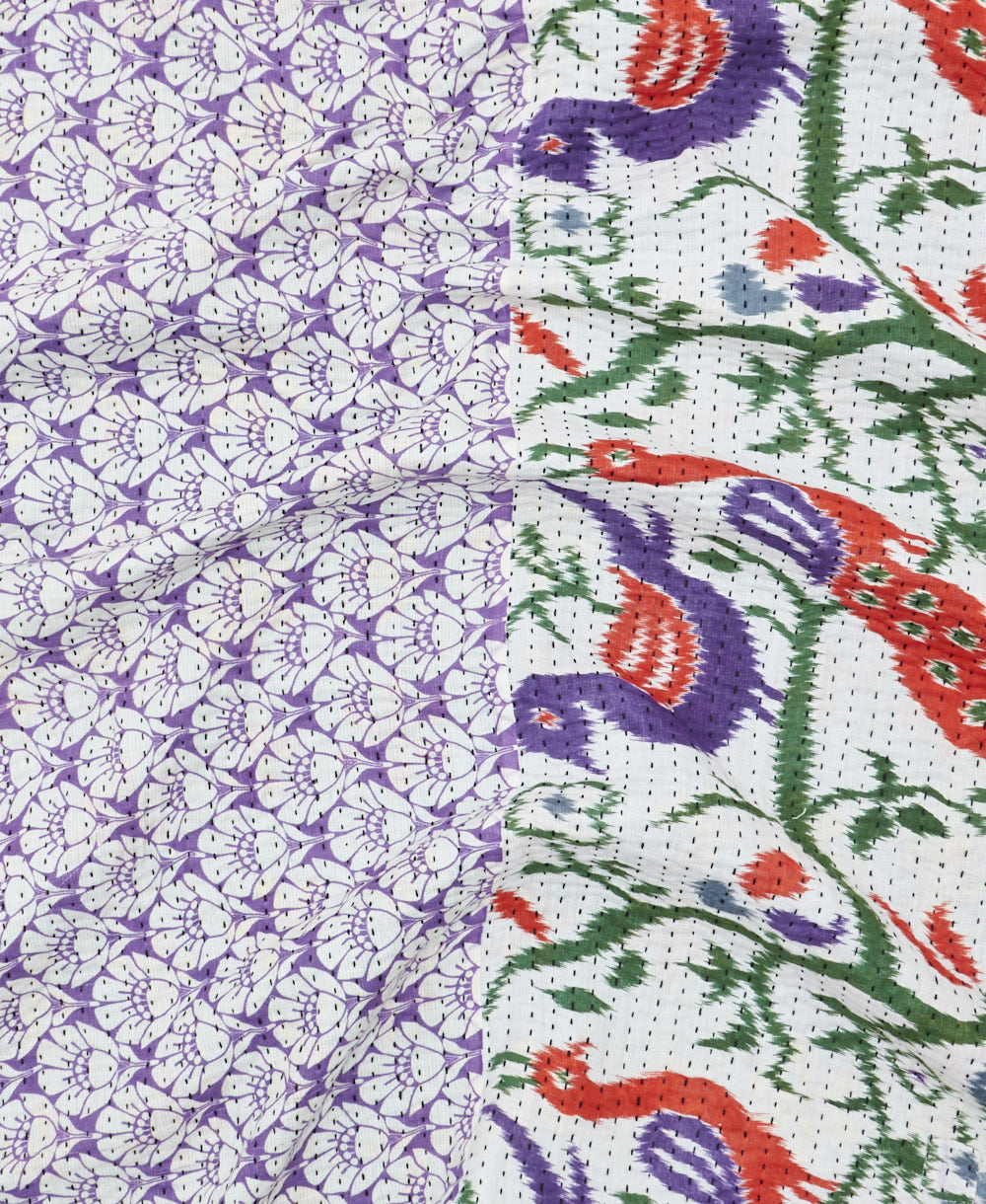kantha quilt throw with a tag featuring the hand-stitched signature of the maker