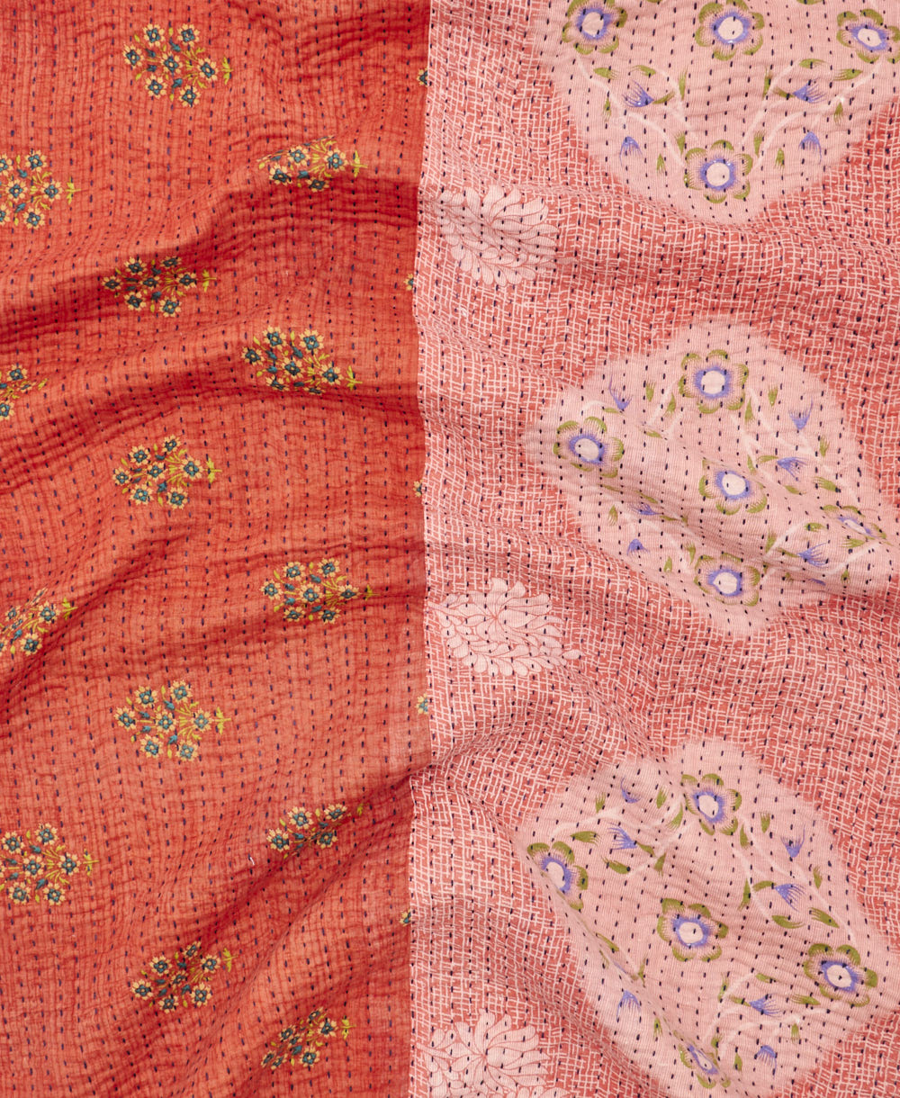 kantha quilt throw with a tag featuring the hand-stitched signature of the maker