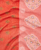 kantha quilt throw with a tag featuring the hand-stitched signature of the maker
