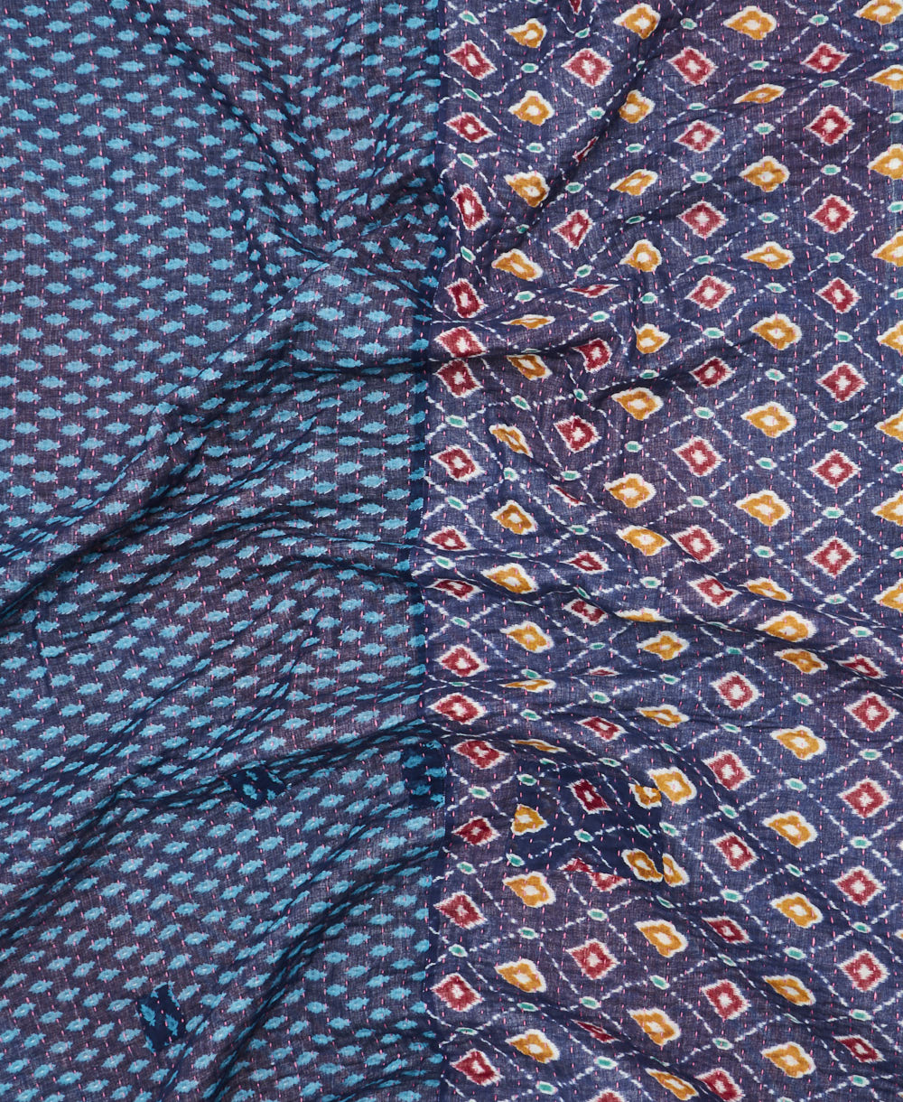 kantha quilt throw with a tag featuring the hand-stitched signature of the maker
